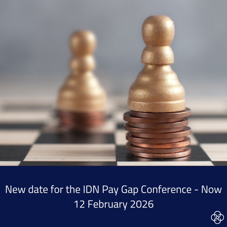 The image shows two chess pawns on top of coin stacks. The pawn at the back is on a shorter stack. The pawn at the front is on a taller stack. The Text at the bottom of the image says: New Date for IDN Pay Gap Conference - Now 12 February 2026