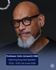 Studio portrait of Professor John Amaechi OBE, shown from the shoulders up against a dark background. Professor John Amaechi is wearing dark-framed glasses and has a closely trimmed white beard. Overlay text reads: “Professor John Amaechi OBE – Opening Keynote Speaker – 10:25–11:20 | 04 June 2026,” with the words “KEYNOTE SPEAKER” displayed vertically near the top left.